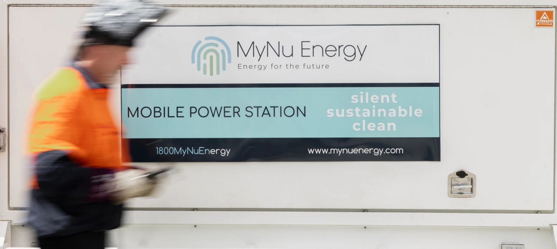 Worker passing MyNu Energy station sign