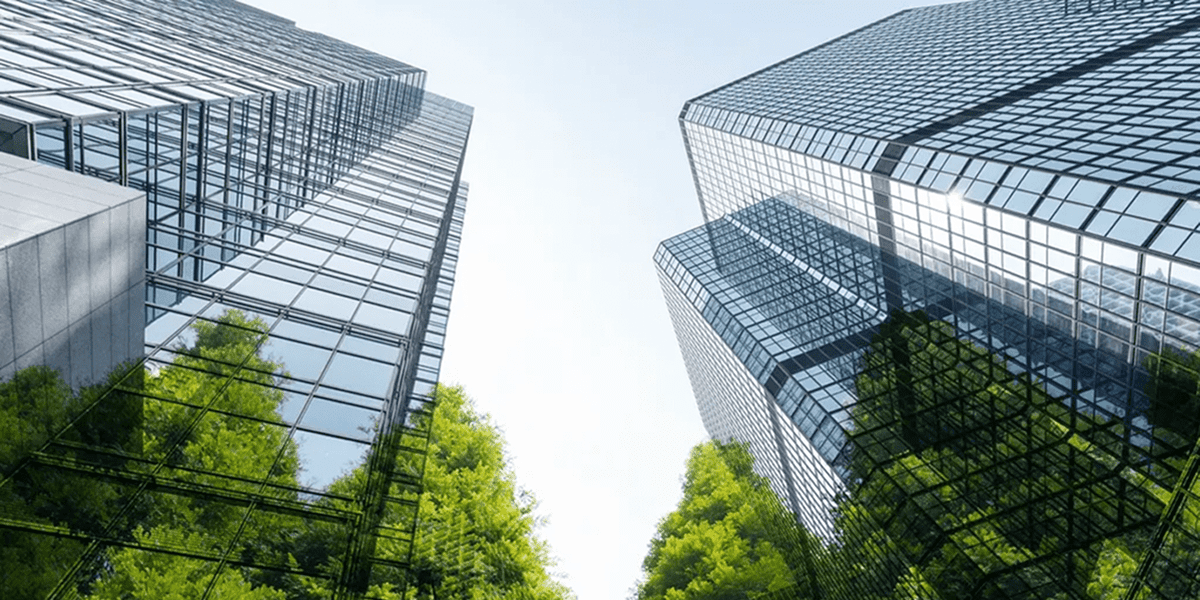 Skyscrapers reflecting green trees below