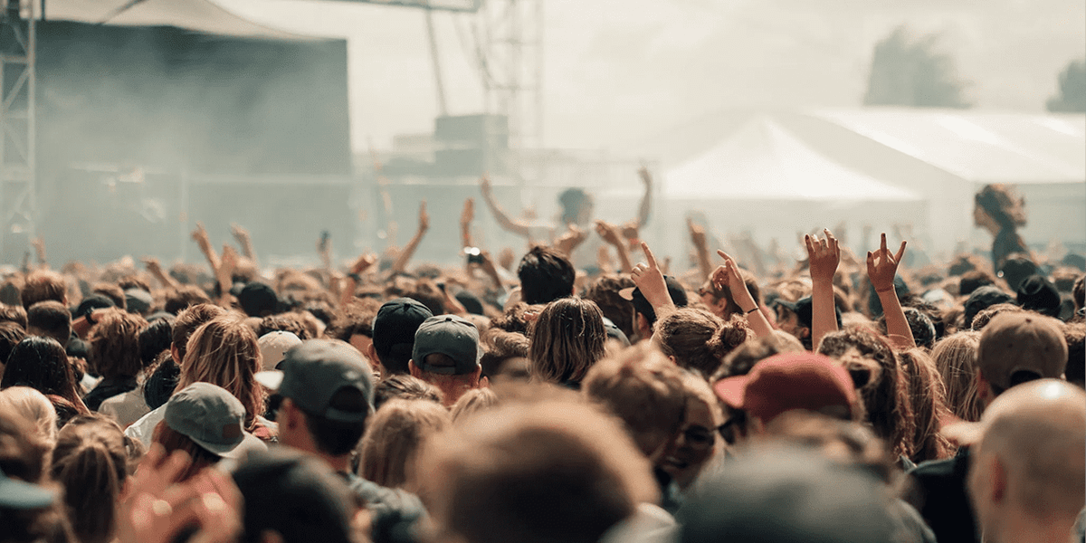 Festival attendees watching a large screen