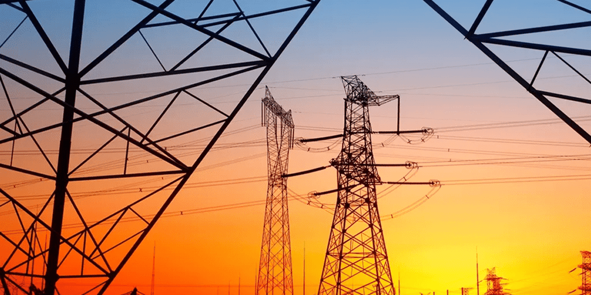 Electrical towers at dusk with colorful sky